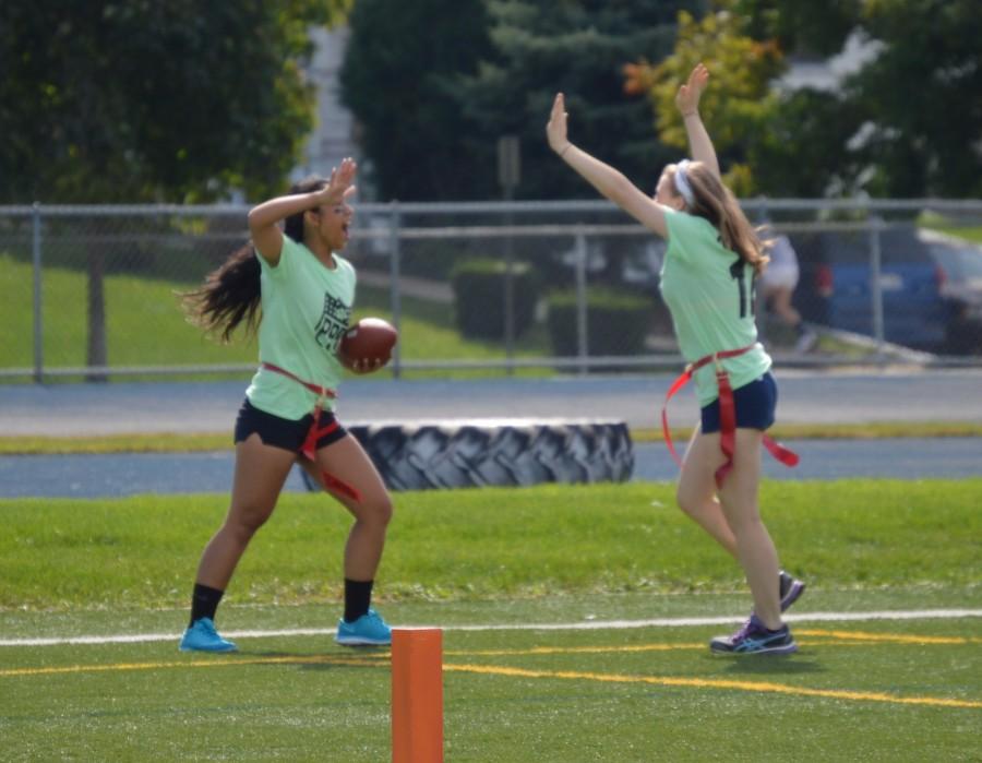 Seniors win for the second straight year with a score of 56-14. Senior Raynne  Belingon scores a touchdown and celebrates with Caroline Cisilino.