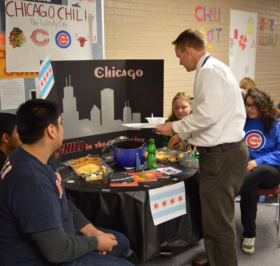 Staff members judged entries from the chili cook-off on Oct. 20. Activities director Marc Wolfe tries a Chicago themed dish that later won first place.