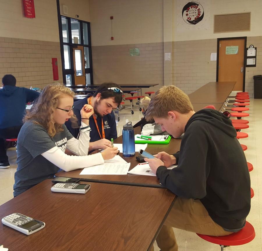 Regionals for math were held at Batavia High School against eight other schools. Math teacher Charles Vokes helps juniors Jenna Palka and David McGhee prepare for a test. 