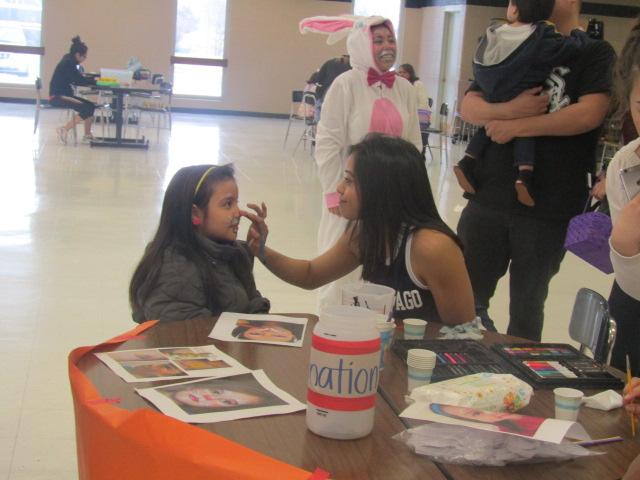 Junior Naara Rodriguez helps out at the Easter egg hunt by face painting. The funds raised for the egg hunt will cover the cost for the Family, Consumer and Career Leaders of America and Skills USA state competition.