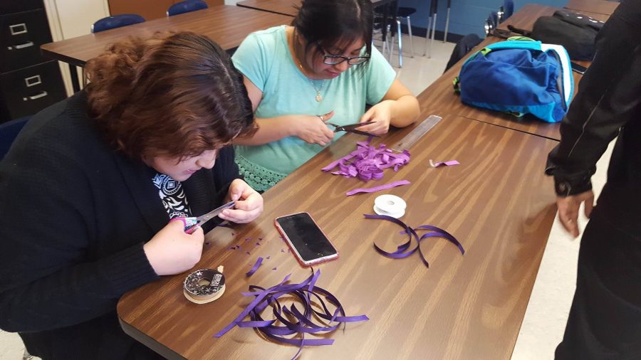 The purple ribbons are an indication that students support the Day of Silence. Members of GSA, sophomores Karen Reyes and Abigail Cielo, help prepare the ribbons. 