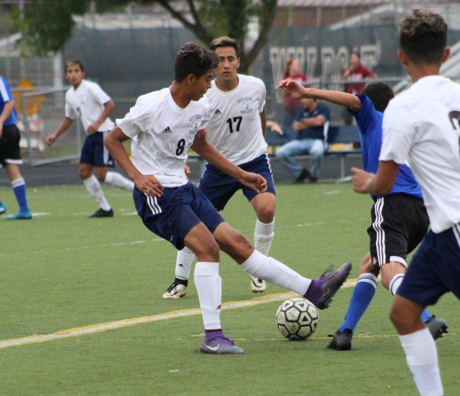 Senior Edgar Pani passes the ball back to senior Guillermo Orizaba, who then takes a shot on net. The teams next home game is Oct. 4 against Bartlett.