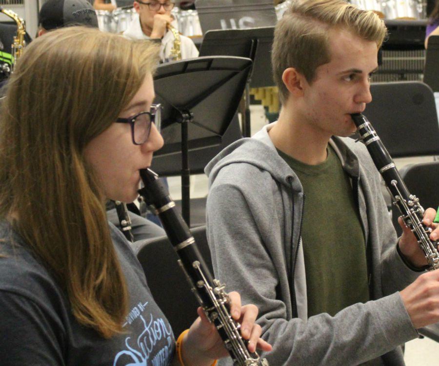 Several students who auditioned for the competitive music program are preparing for their concert on Nov. 25. Junior Sean Renwick and senior Jenny Manspeaker rehearse during band class.