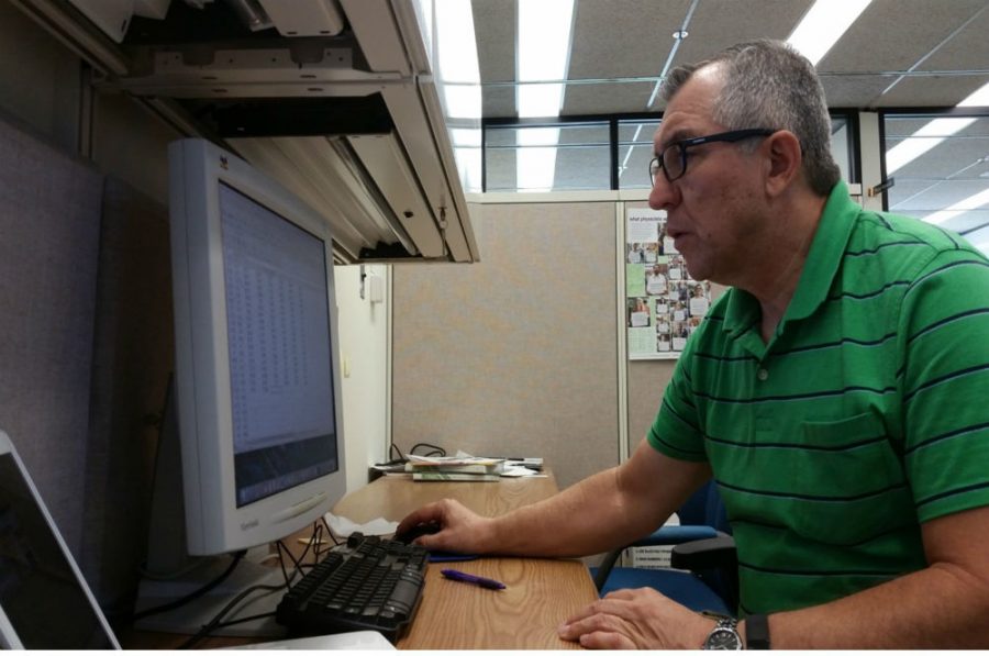 Science and math teacher Eduardo Montoya works on an assignment as part of his learning experience at Fermilab.