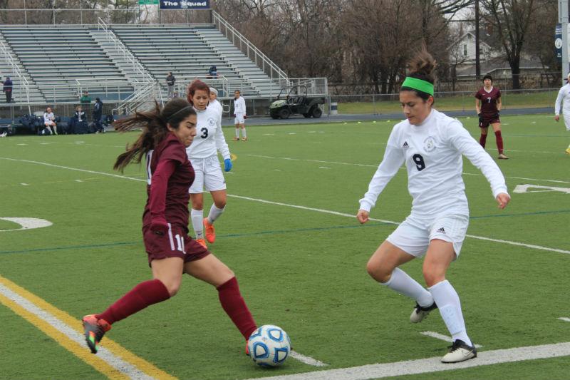 Midfielder Jasmine Mendoza tries to block the ball against Elgin High School. The team tied with a score 1-1.
