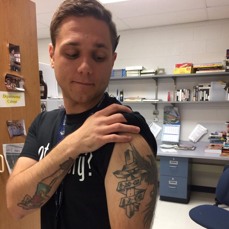History teacher Joseph Zeman shows one of his many tattoos