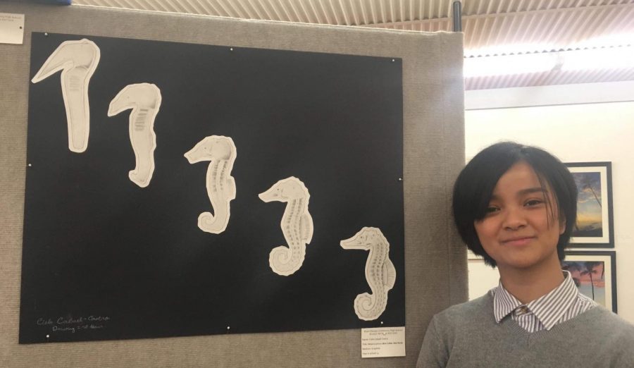 Freshman Cielo Cabael-Castro visits the open reception at Gallery 200 to present her artwork on display. 