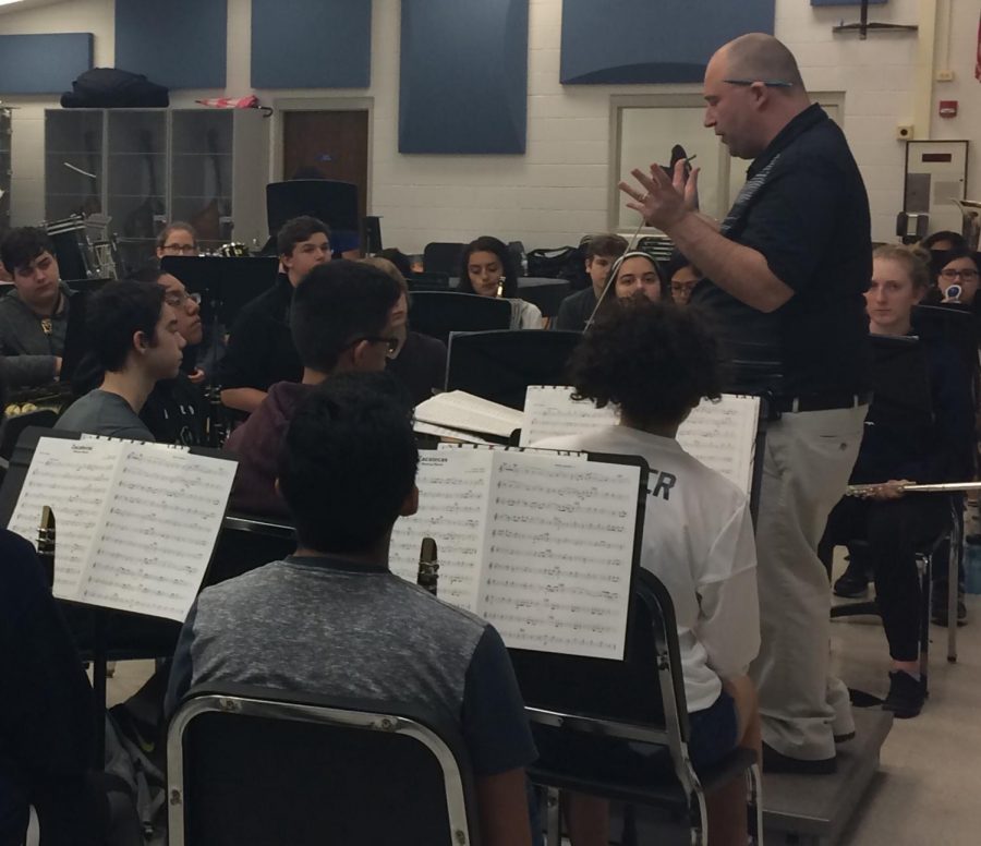 Band director James Wallace prepares students for the last band concert of the year on Wednesday in the auditorium.