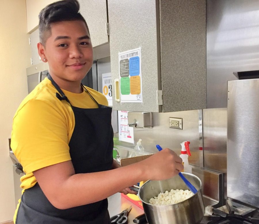 Senior Jay Ratphimpha bakes rainbow pretzels in the family and consumer science kitchens for their homecoming bake sale.
 
