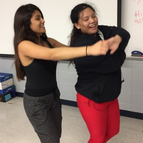  Students learn the basics of merengue in Alegria’s first meeting of the year Monday.  From left, 3-year member Gladys Gomez teaches sophomore Suleima Montoya how to do a ‘sweet heart.’
