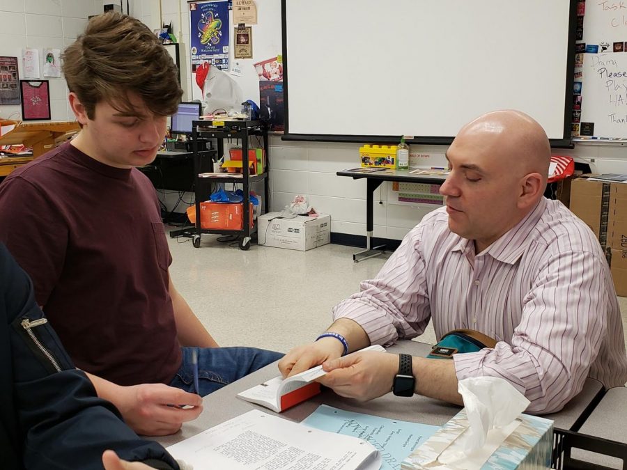  Drama teacher Mark Begovich helps junior Nathan Bradley develop his character for a play. 
