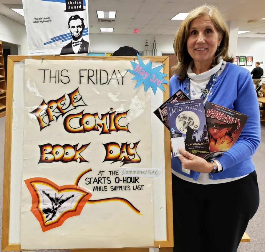 Librarian Donna Leahy holds free comics that will be given out to honor free comic book day Friday. 