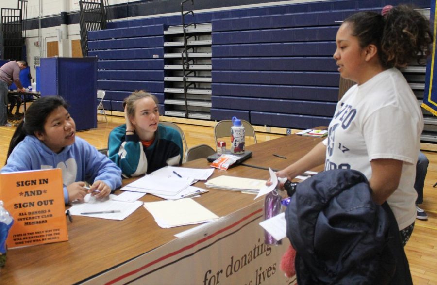 Junior Guadalupe Rosales meets with Interact members Flora Nei (19) and Ruby Lebo at last years spring blood drive. 