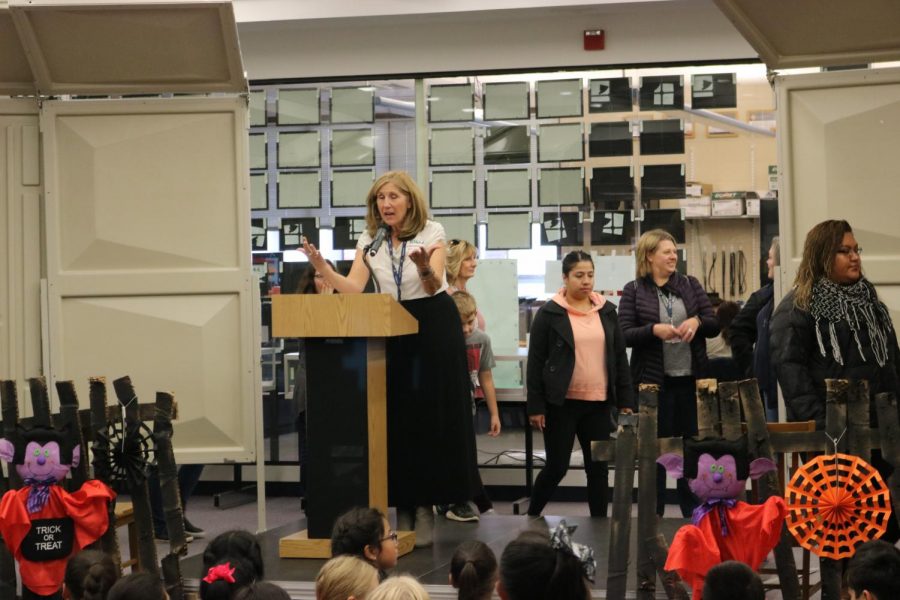 In 2019, librarian Donna Leahy speaks at the Dare to Scare event in front of students. 