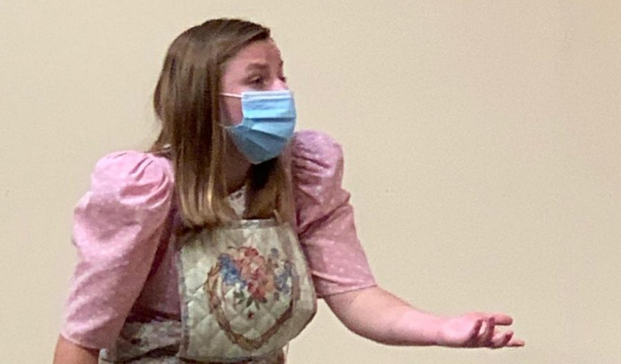 Junior Maggie Hancock adheres to CDC guidelines, wearing a mask while performing. 