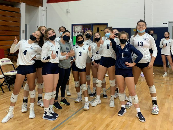 The 2021 girls volleyball team poses after a recent match.