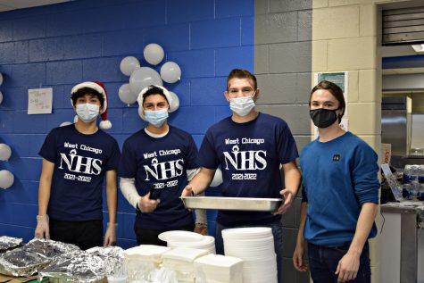 NHS members Anthony Cielo, Javi Garcia, Kyle Prebis and Jason Sartore serve pancakes to guests.