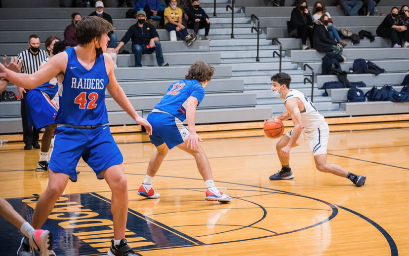 Kostomiris crossing over the opposing defender