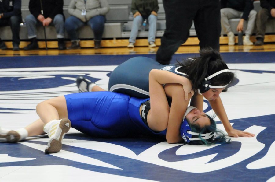 Senior Tania Cristobal takes down an opponent in a recent wrestling match.
