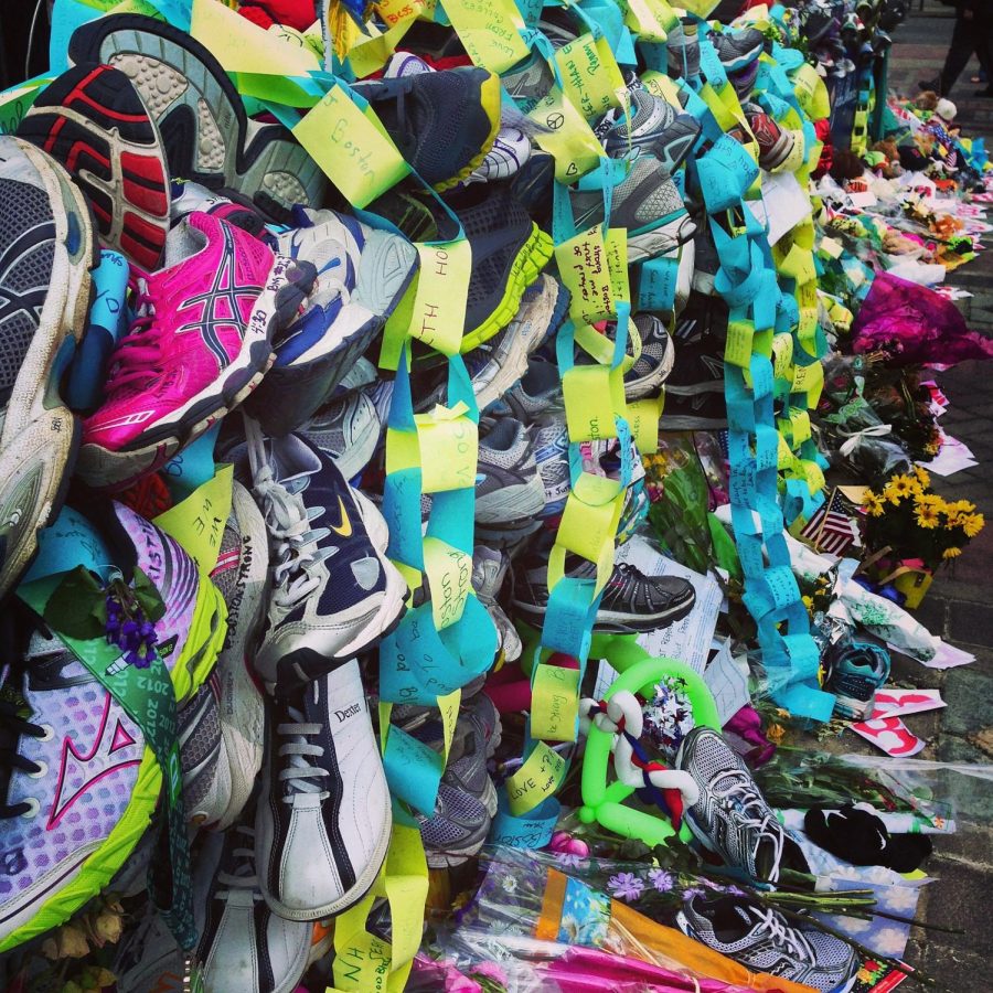 Running shoes line the street following the bombing at the 2013 Boston Marathon. (Royalty-free photo by Sarah Nichols via Wikimedia Commons)