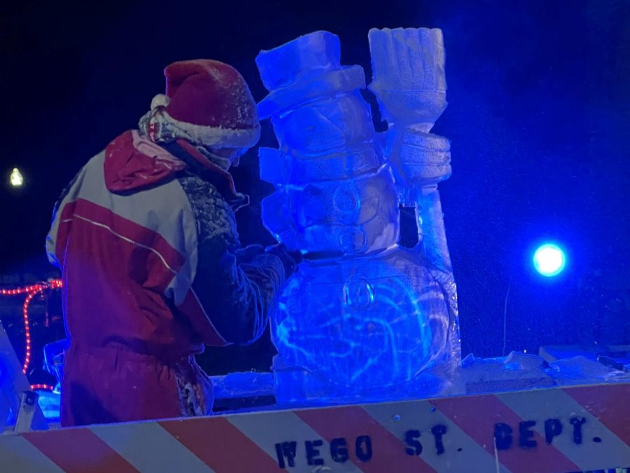 A bundled-up artist works on an ice sculpture at Frosty Fest on December 3.
