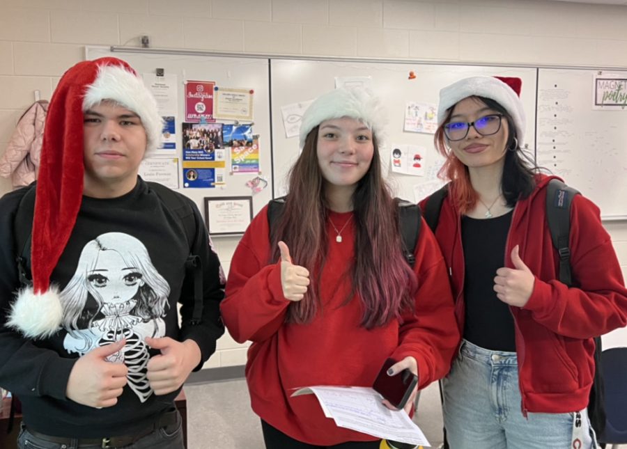 Chronicle reporters Dago Alfaro, Sofia Tamayo and Jetzelli Hernandez don Santa hats during the Winter Spirit Week at WEGO.
