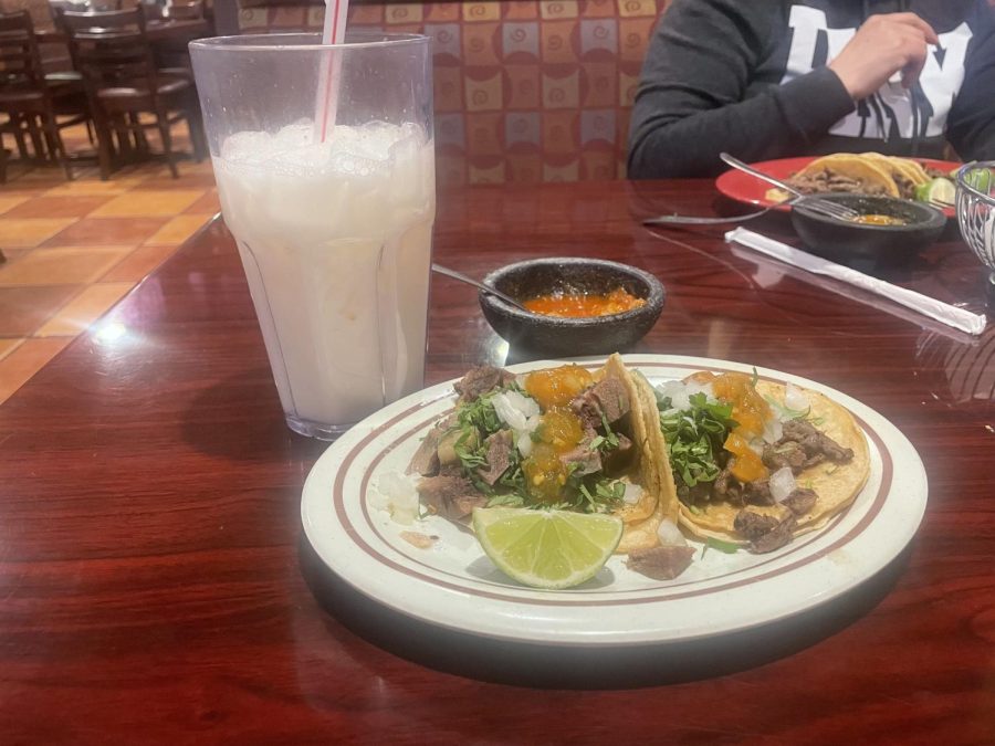 The+Mexican-style+tacos+at+El+Coco+Loco%2C+pictured+with+a+glass+of+horchata.