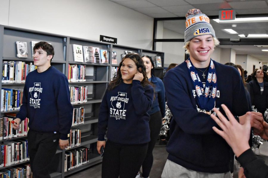From left to right, champions Allen, Huesca-Rodriguez and Johnson made their way through the LRC, high-fiving fans as they walked past. The Parade of Champions concluded its march – one for the record books.