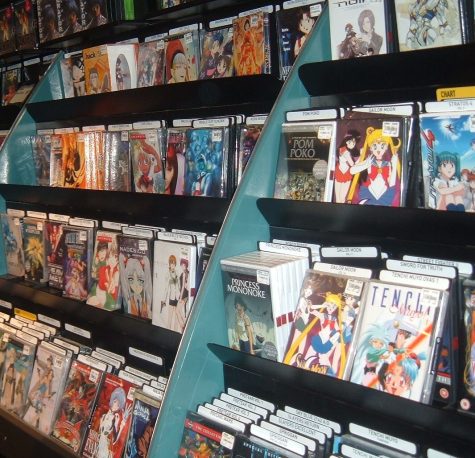 Vintage anime DVDs line a shelf in a shop. (Photo courtesy of Wikimedia Commons, no named photographer)