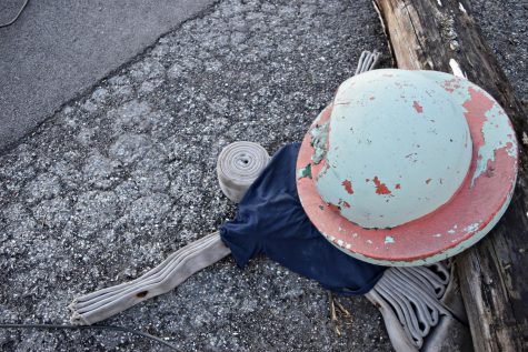 An injured dummy is crushed under a pole that was knocked over by a car during the disaster simulation.