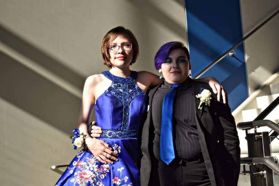 Although this years Prom was hosted at the Museum of Science and Industry in Chicago, promgoers met at the school to travel via coach bus to the city. Juniors Elizabeth Horan and Alin Hunt wait inside Entrance B.