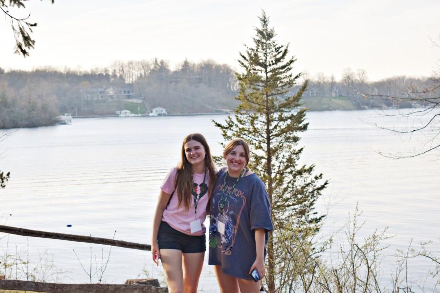 Two officers from West Chicago Community High Schools National Honor Society chapter, juniors Lauren Sikma and Mia Valliquette, pose for a photo by the lake that surrounded the camp. 