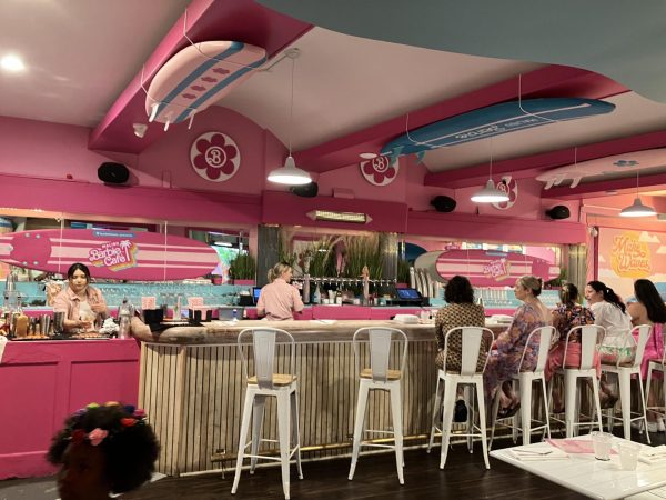 The bar scene at the Barbie Malibu cafe. There are bar seats available as well as tables. 