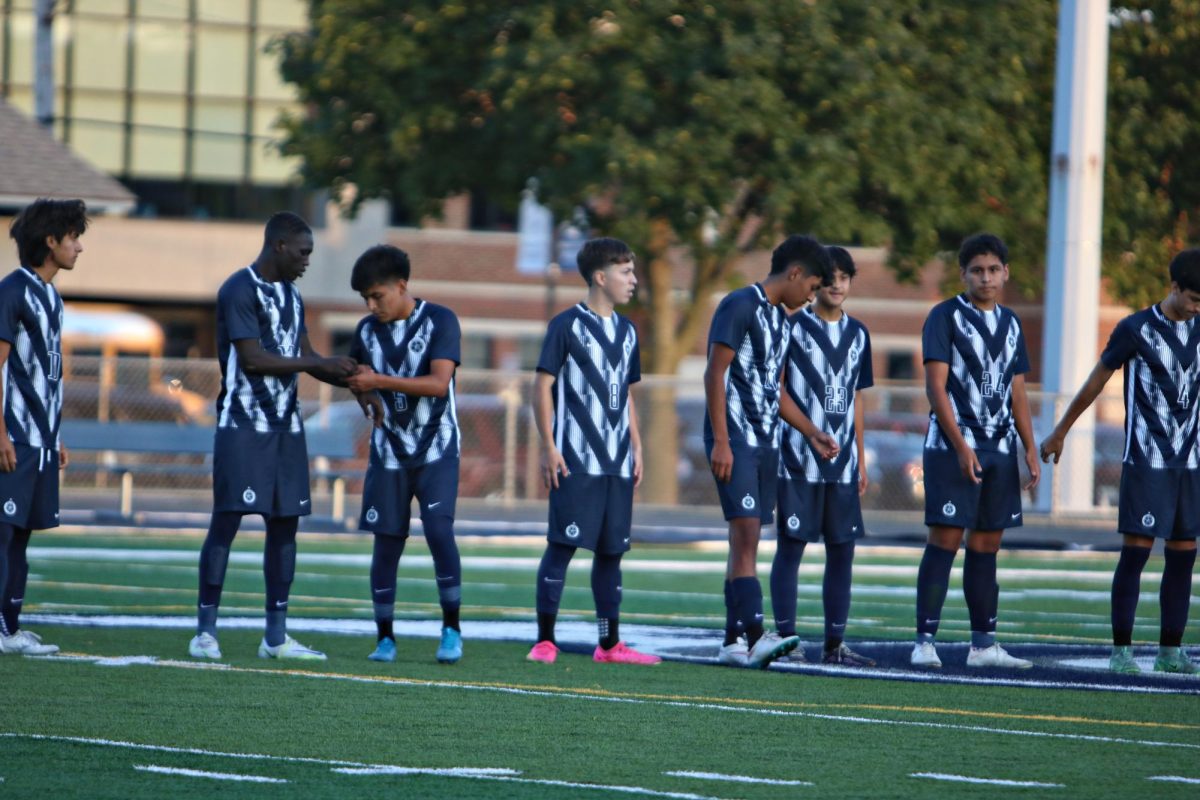 The Varsity boys soccer team lines up at the start of the game, prior to kick-off.