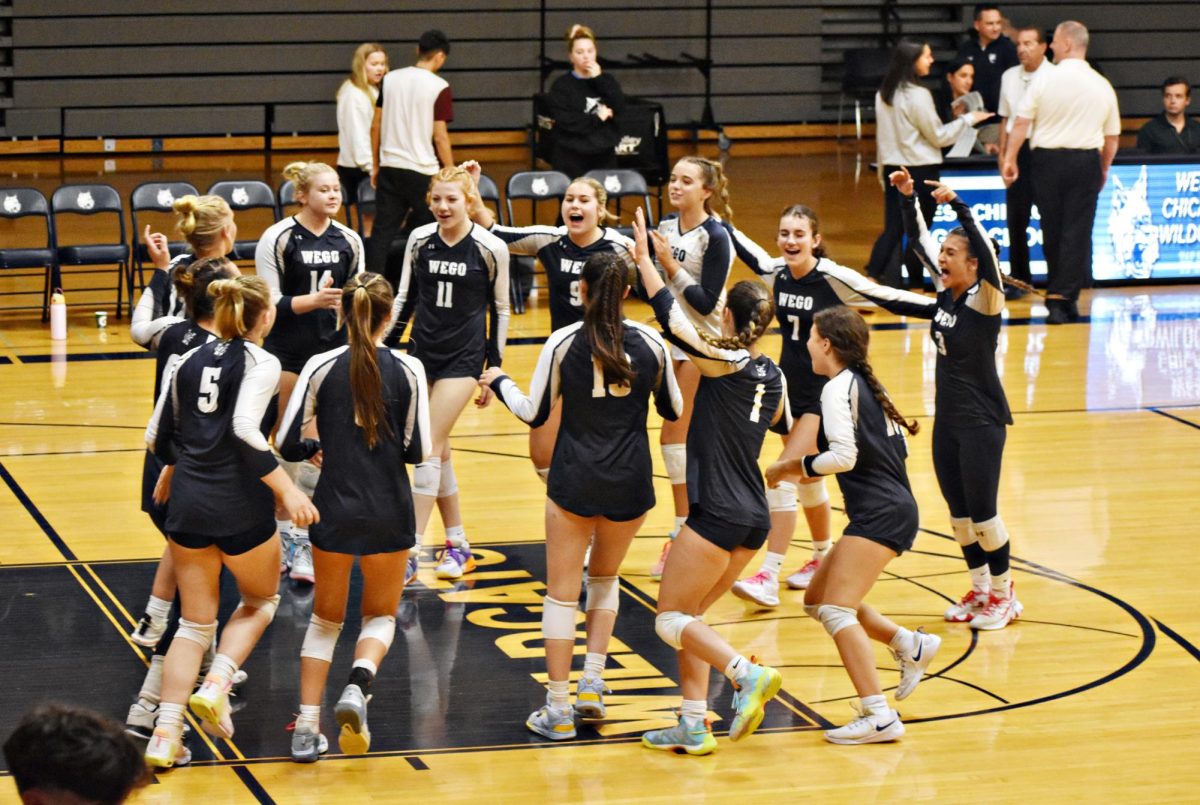 The girls team rallies during a timeout on Sept 21 in Bishop Gym.