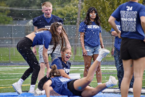 Pep Club members monitor the slip and slide relay race during the final competition of the event.