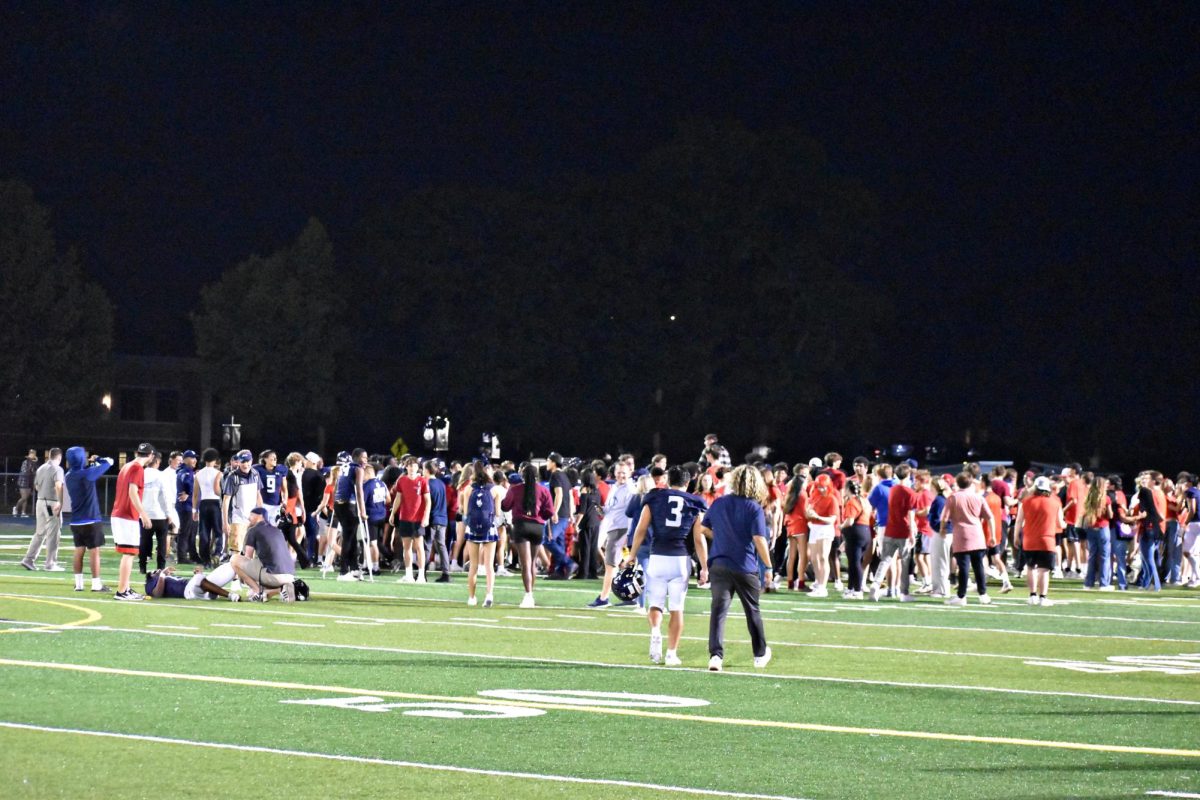 Fans and coaches mob the West Chicago Wildcats following their victory against the Bartlett Hawks on Sept. 1.