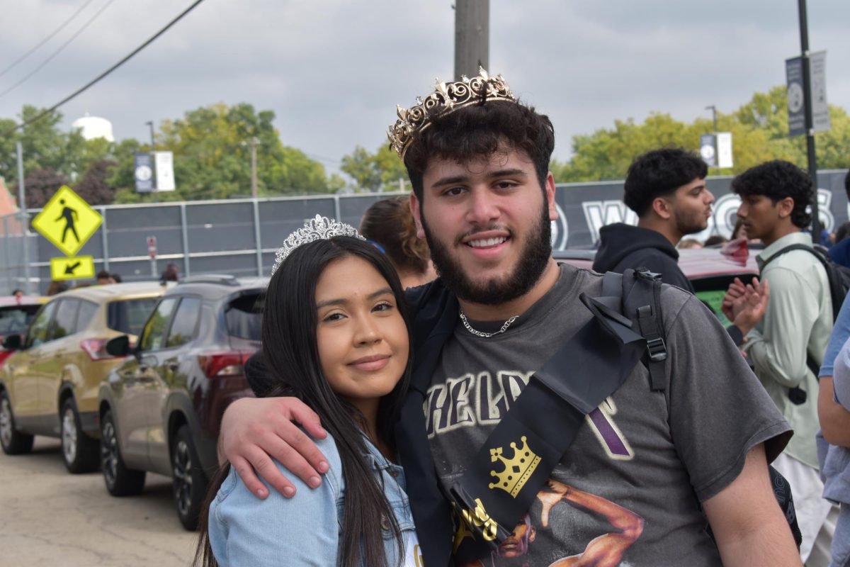 Homecoming King/Queen and fellow Chronicle Reporters Qssam Alwan and Karen Huerta pose at the start of the parade following their crowning at the Pep assembly.