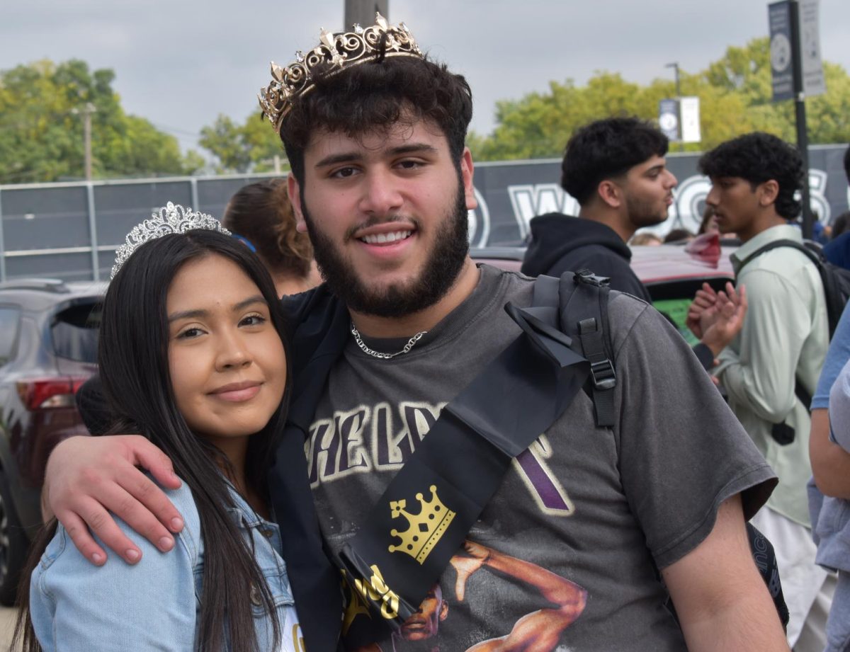 Homecoming King/Queen and fellow Chronicle reporters Qssam Alwan and Karen Huerta Garnica pose at the start of the parade following their crowning at the pep assembly.