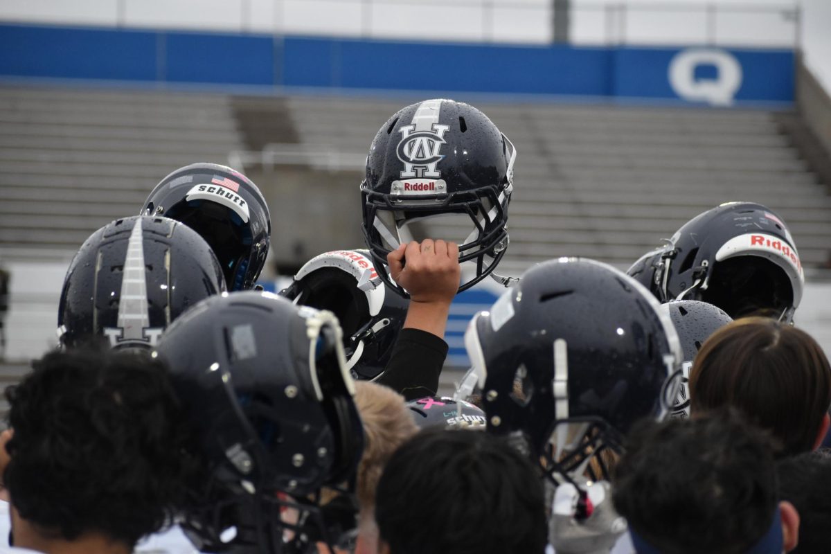A lone player on the West Chicago Community High School holds up his helmet as a sign of hope following the teams loss to Quincy.