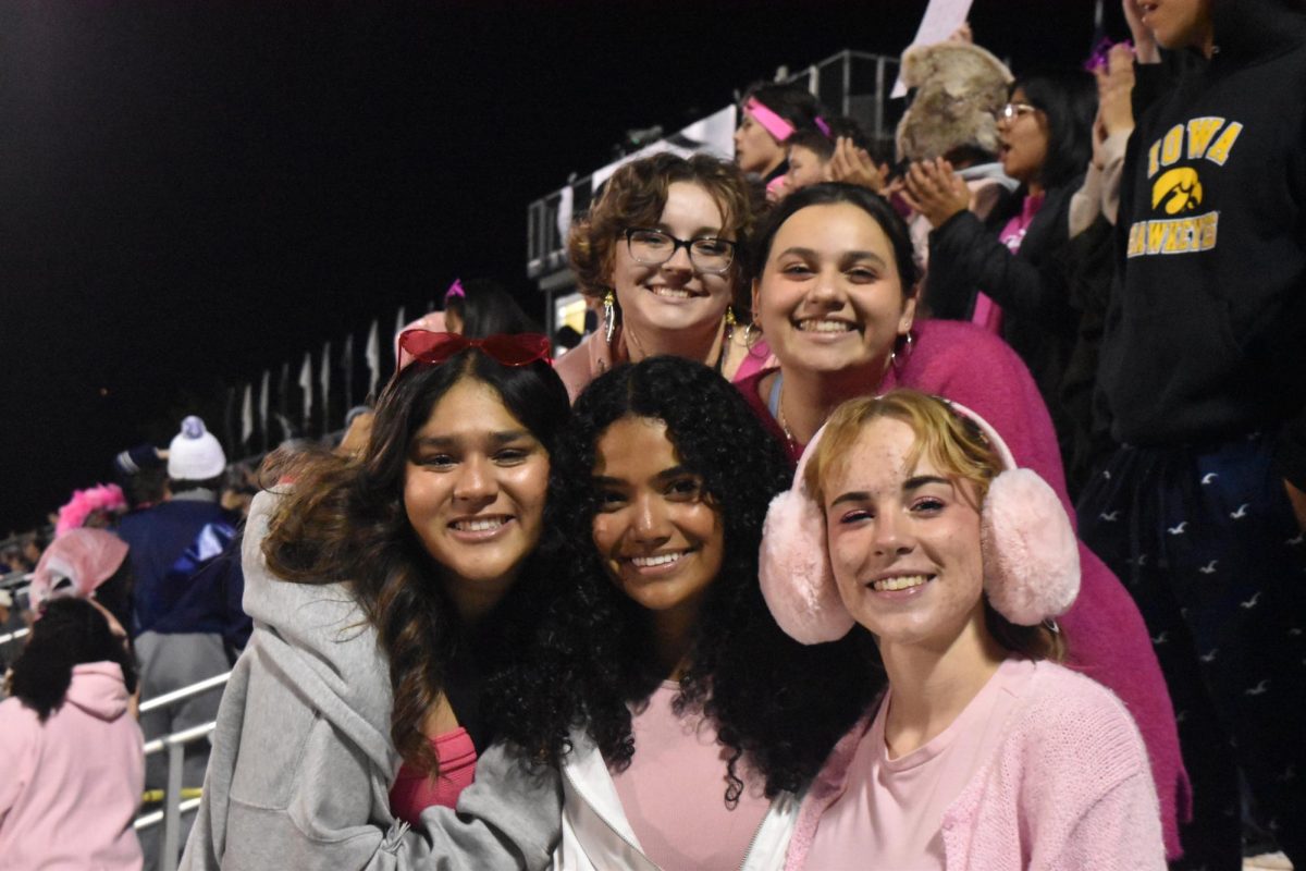 Football supporters don pink outfits - and ear muffs - for the late season game.