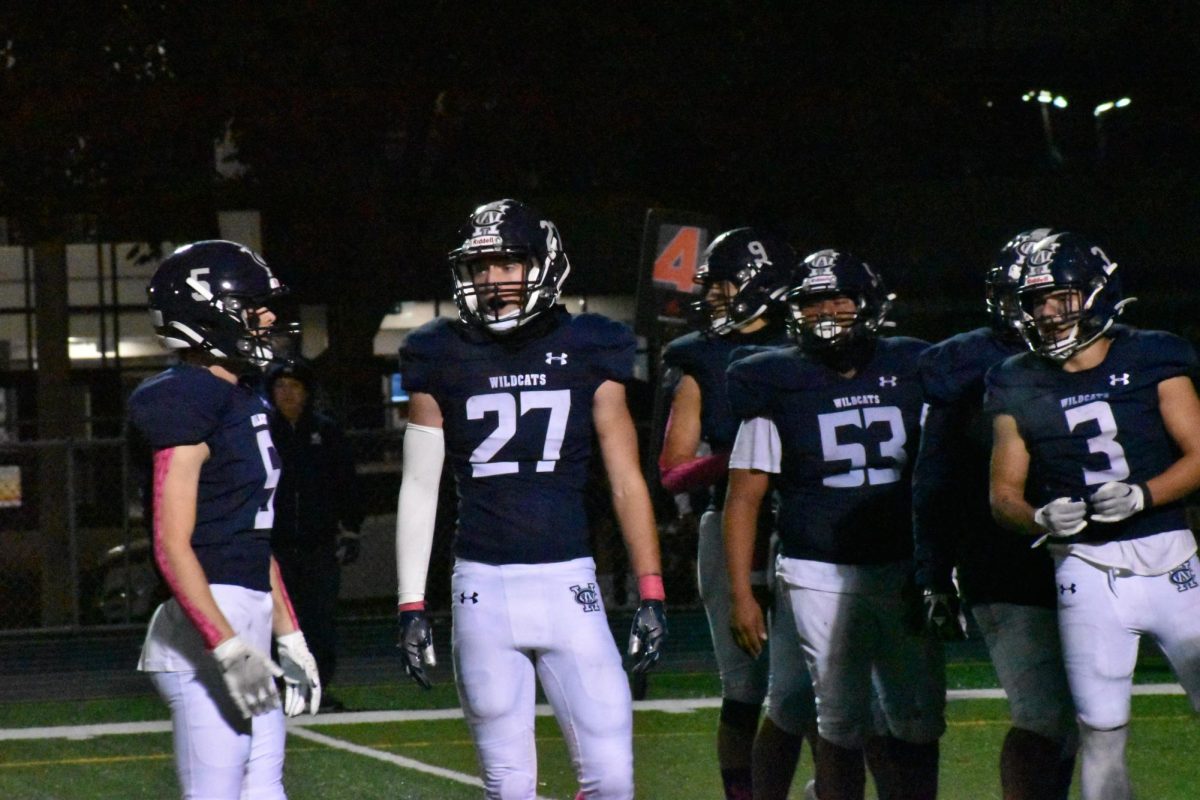 Sophomore David Weber awaits direction from junior Tommy Murphy.