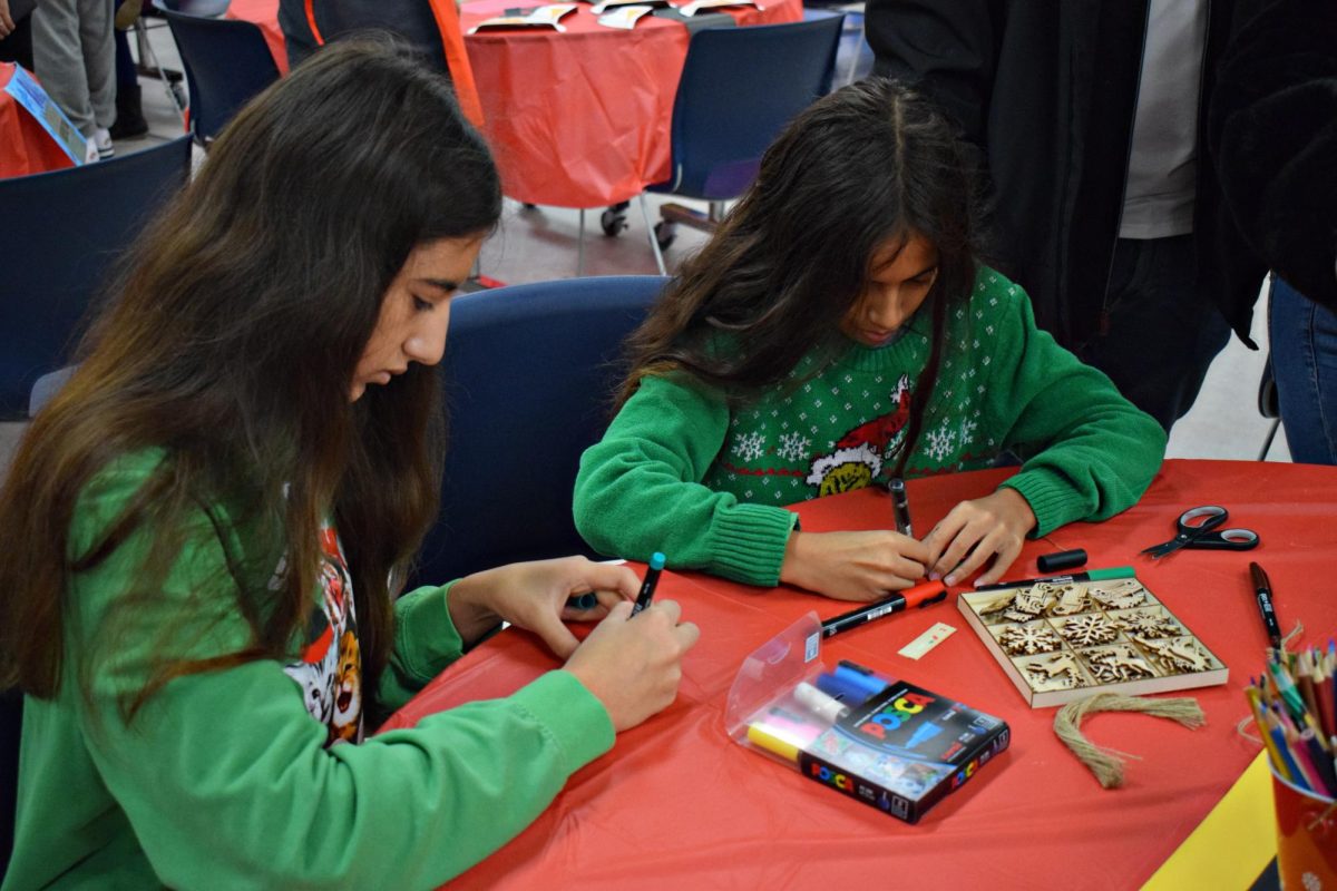 Senior Diana Makintos and her younger brother decorate ornaments in Commons. 