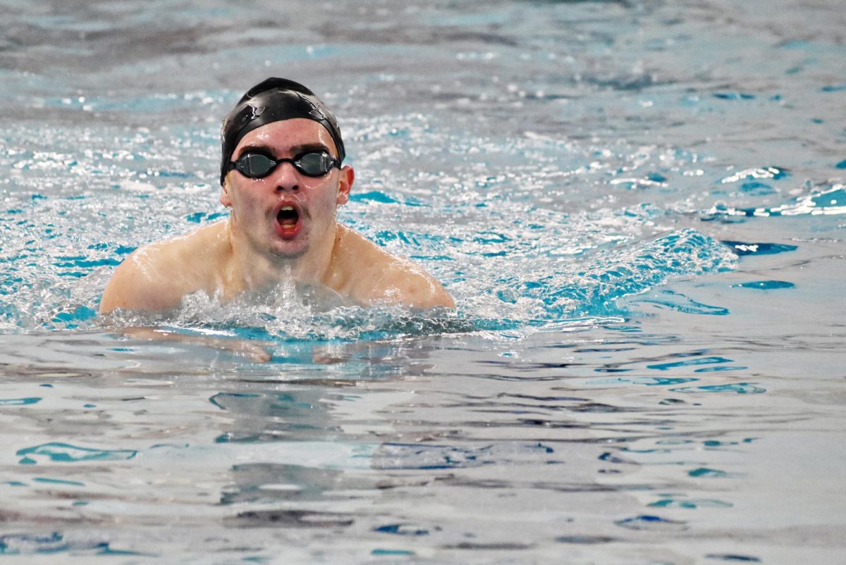 A Bartlett Saber Hawks swimmer grabbing a breathe while competing in the breaststroke.