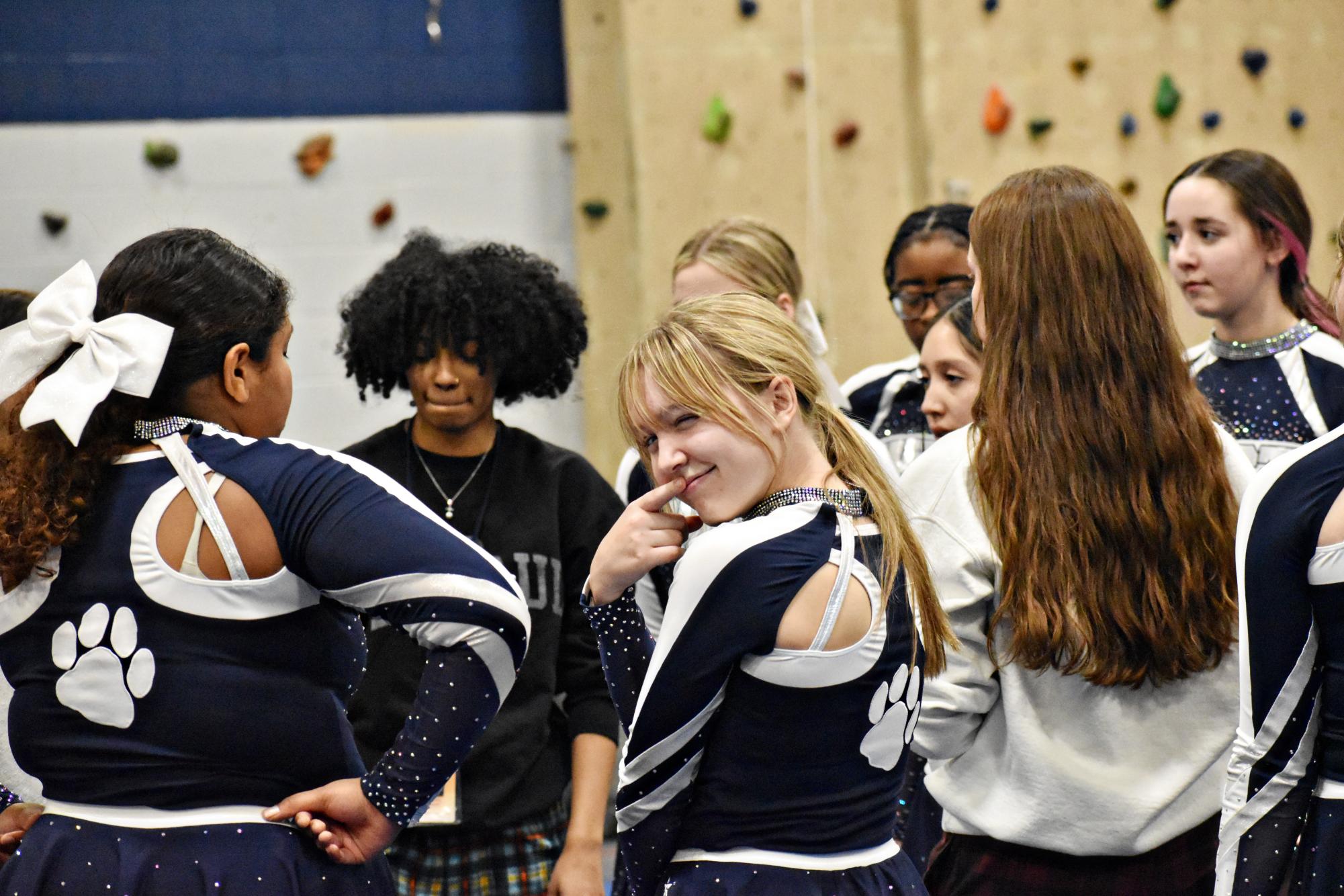 Sophomore Avery Unger seems to be in on the secret as the cheer team strategizes ahead of its next competition.