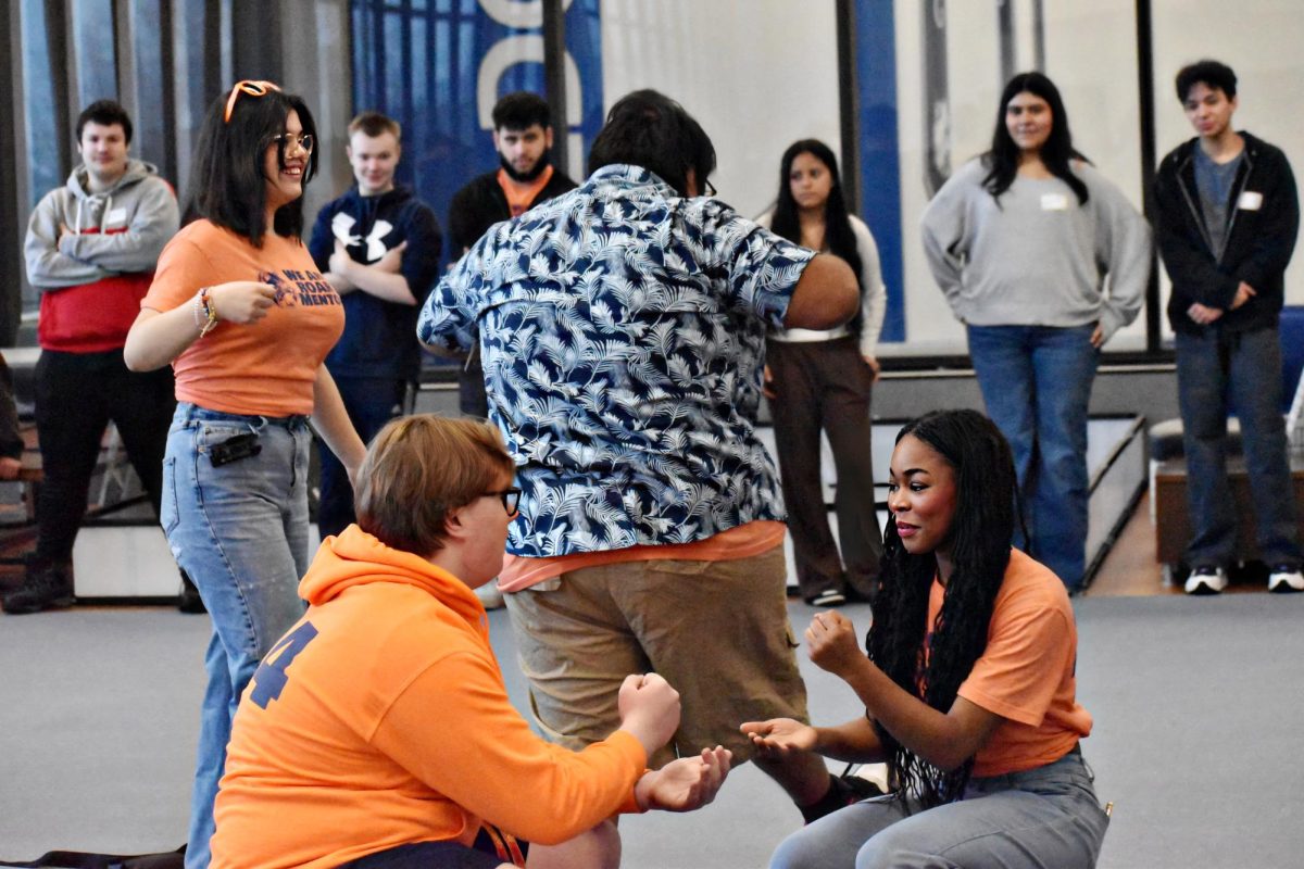 ROAR mentors Jake Voight (junior) and Karidja Monjolo (senior) demonstrate a game called Egg, Chicken, Dinosaur as an opener to the activities that will be occurring throughout the day.
