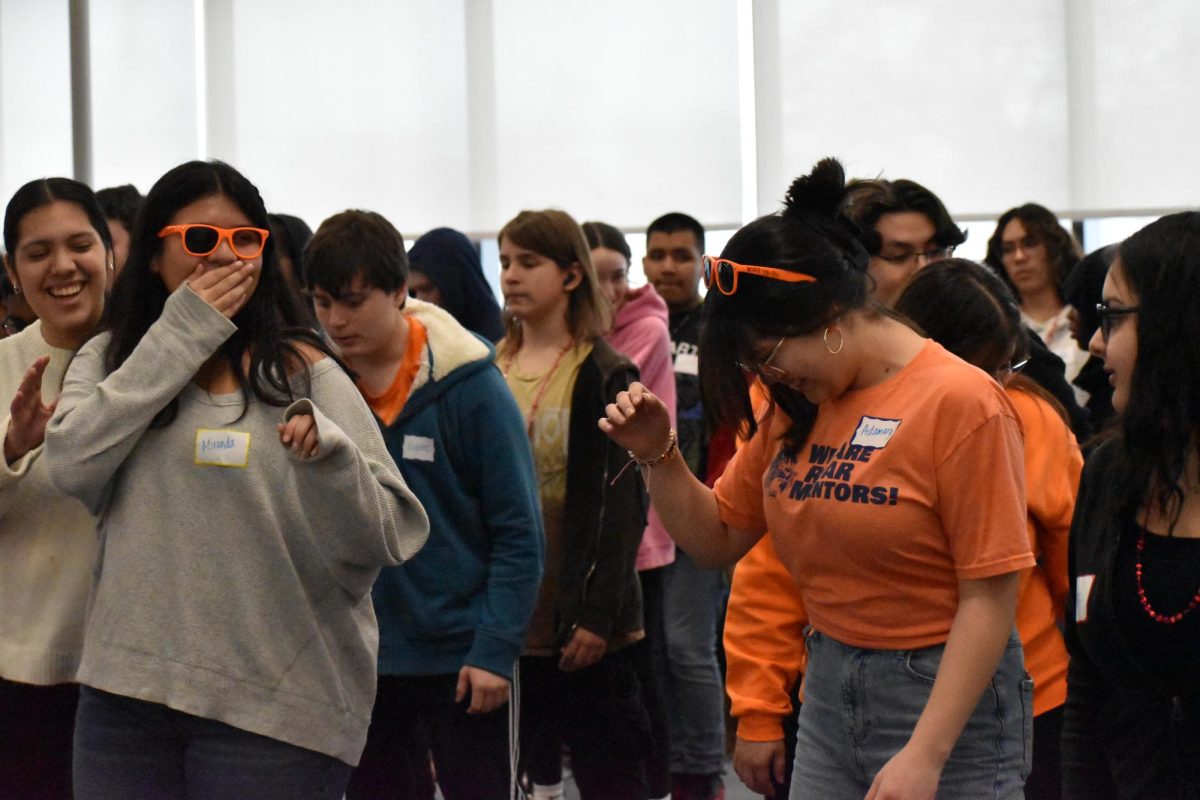 At the end of the day, mentors and attendees learn to follow a group dance alongside friends.