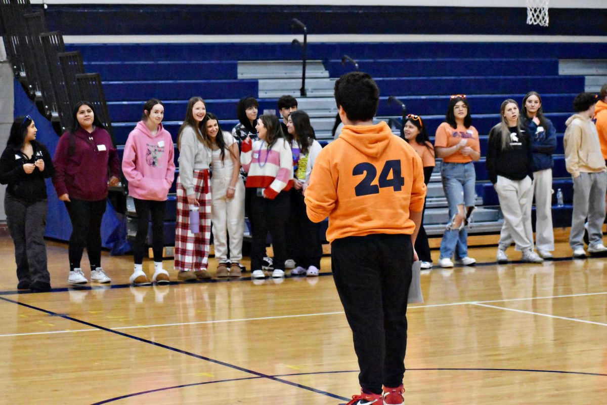 Students gather within the small gym for Cross the Line, an activity to help demonstrate that students are not alone with their struggles.