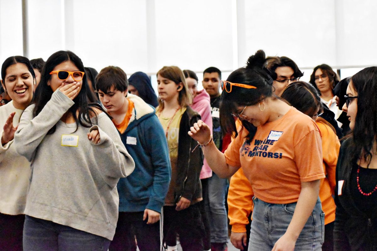 At the end of the day, mentors and attendees learn to follow a group dance alongside friends, including juniors Miranda Bucio (left) and Adamary Vega (right).