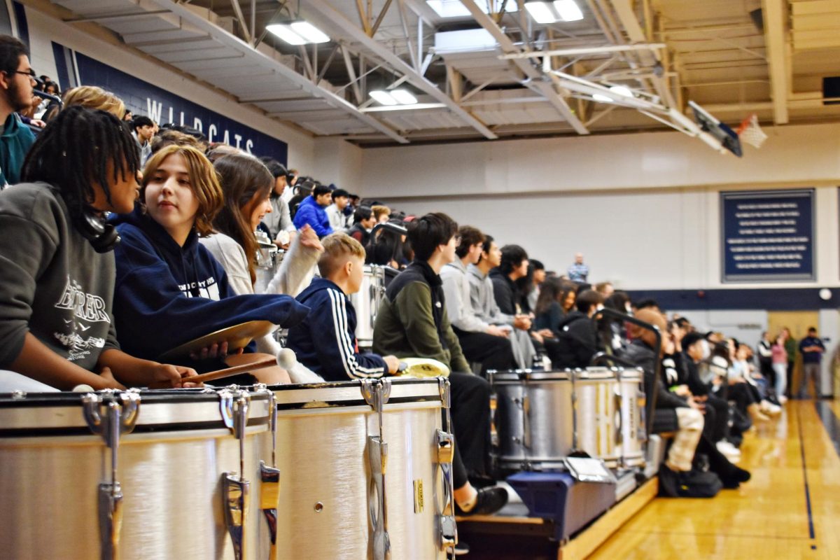 The drumline performs along the sideline of Bishop Gym.